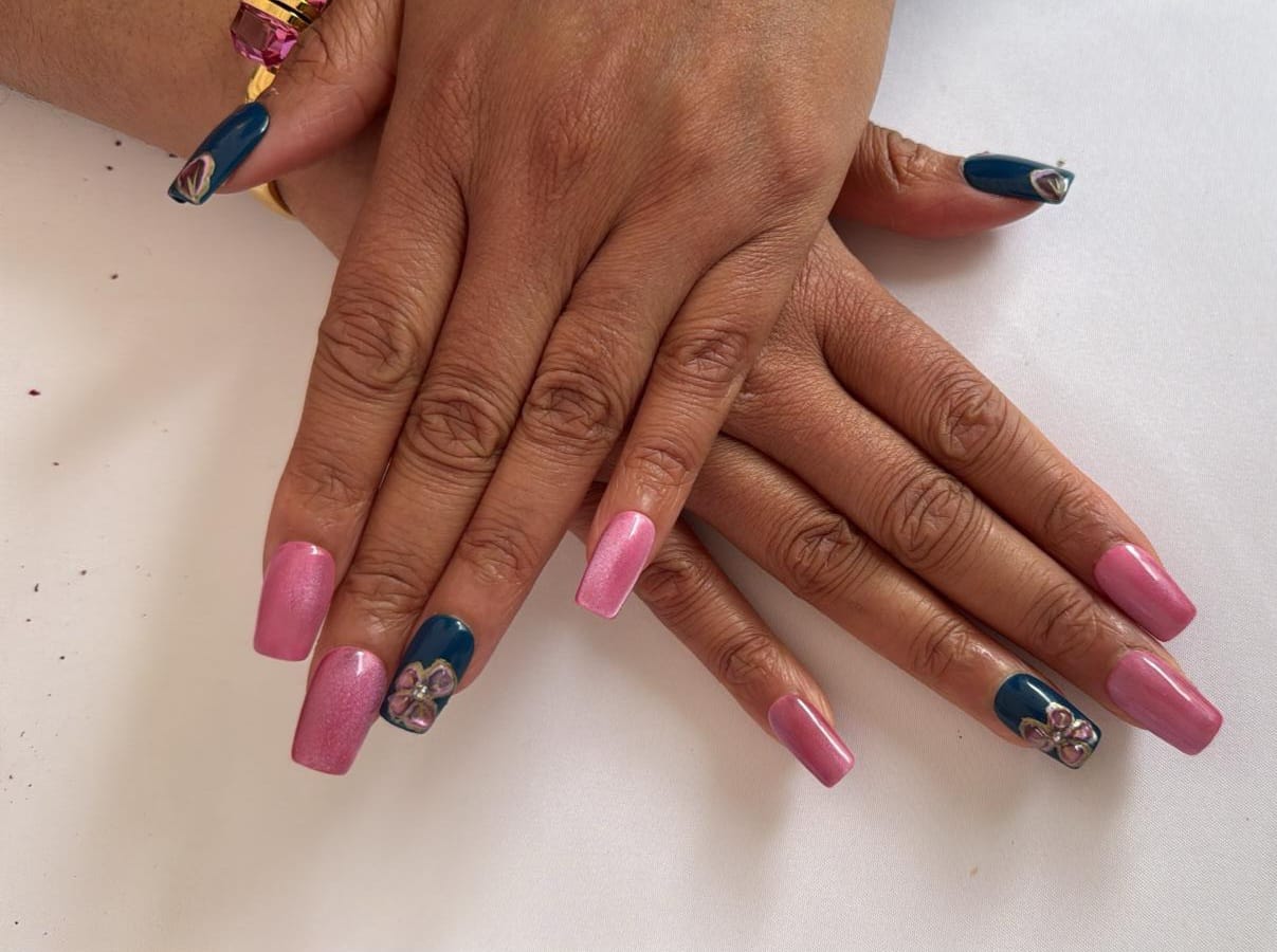 Pink cat-eye design with teal and 3D flower gems